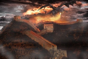 A dragon breathes fire along a city wall with four towers.